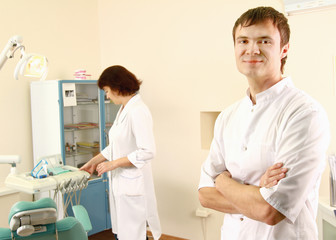 Man dentist at his office smiling