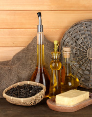 Different types of oil with sunflower seeds on wooden