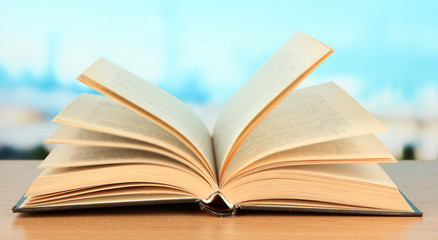 Opened book on bright background