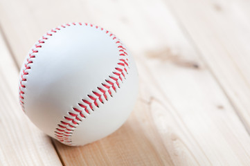 Baseball ball on wooden boards, horizontal shot