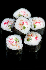 Dragon rolls over black background, vertical shot