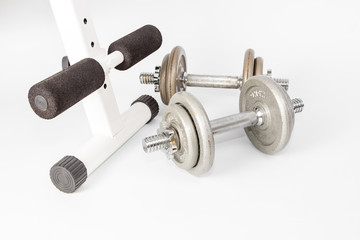 Silver metal dumbbells, one on another isolated on white