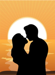 silhouettes of loving couple at sunset