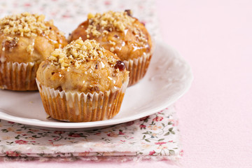 Banana muffins with walnuts and white chocolate on a plate