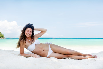 Portrait of a happy young woman posing while on the beach
