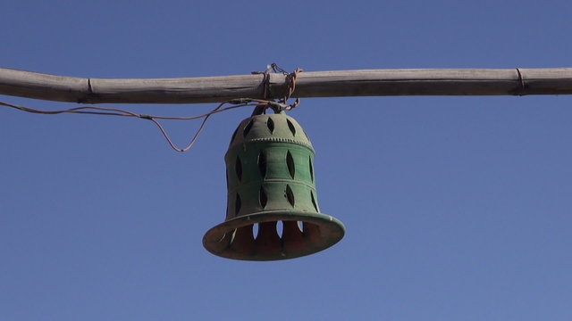 ceramics bell form lamps on bamboo in India