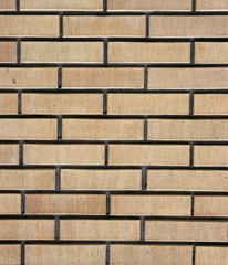 Brick wall. The facade view of beige brick wall.