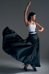 girl dances in a black silk skirt