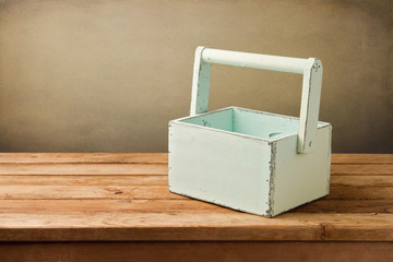 Empty wooden box on table over grunge background