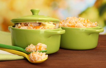 Rice porridge with pumpkin in saucepans