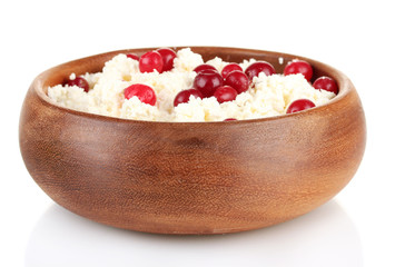 Cottage cheese in color bowl with red berries, isolated on