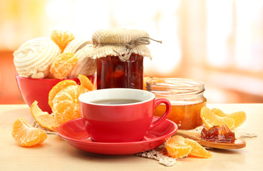 light breakfast with tea and homemade jam, on wooden table