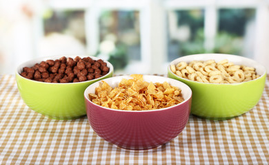 Delicious and healthy cereal in bowls on table in room