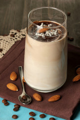 Glass of chocolate-cream cocktail on wooden table close-up