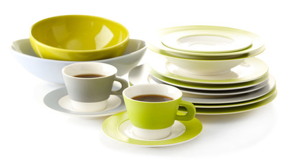 Empty bowls, plates and cups of tea isolated on white