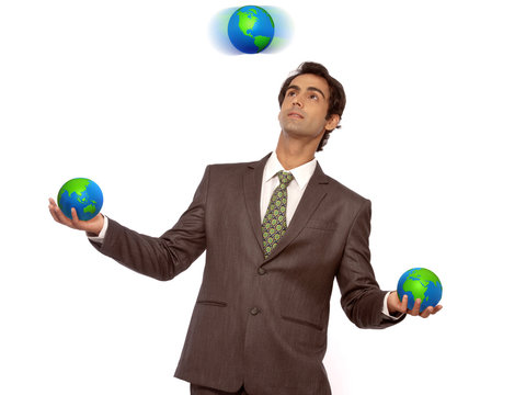 Business Man Juggling With Earth