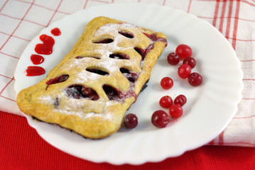 Cake with cranberries on decorated table