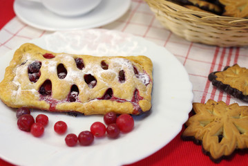 Cake with cranberries on decorated table