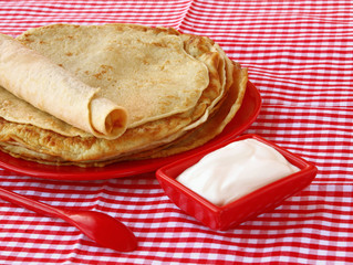Pile of pancakes and sour cream on Shrovetide