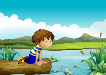 Een jonge jongen die naar de vissen kijkt © GraphicsRF