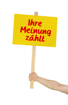 Person h&auml;lt Schild mit der Aufschrift Ihre Meinung z&auml;hlt