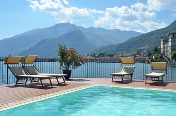 Row of sunbeds against Como lake, Italy