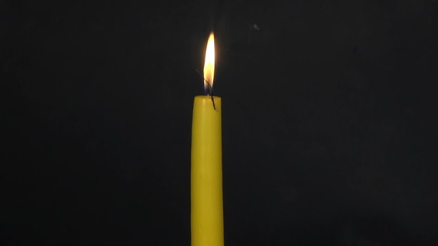 Burning-down yellow candle. Time lapse 1