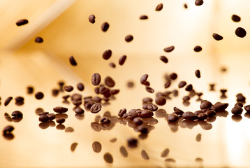 Flying coffee beans on a abstract background - obrazy, fototapety, plakaty