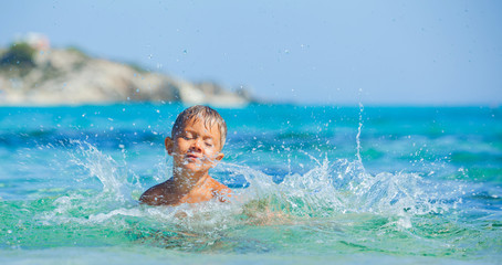 Young boy swimming in sea