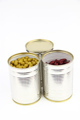The tins with peas and red bean on the white background