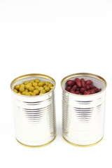 The tins with peas and red bean on the white background