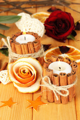 Decorative rose from dry orange peel and burning candles