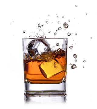 whiskey splash with ice cubes isolated on white