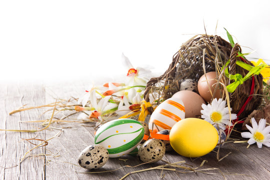 Colorful easter eggs with brown basket