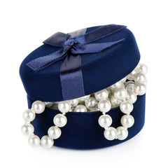 Pearl beads in the slightly opened casket isolated on white