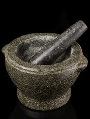 Granite mortar used for making sauces isolated on black