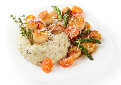 Risotto with pan seared sea scallops isolated on white