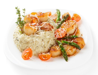 Risotto with pan seared sea scallops isolated on white