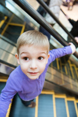 Cute little boy on escalator