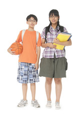 School children, boy and girl, with backpacks ,ball