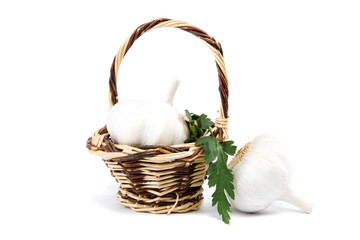 Fresh bulbs of garlic in basket on a white background.