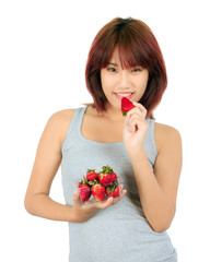 Isolated young asian woman with a box of strawberries