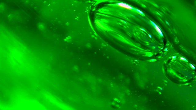 Small bubbles in green gel moving.  Extreme macro.