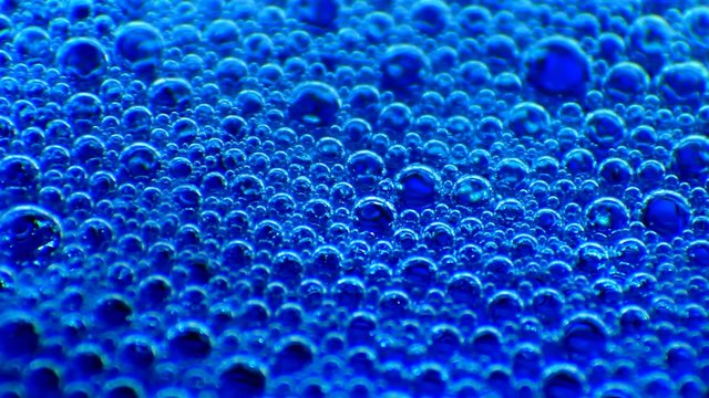 Blue bubbles in water. Extreme macro.