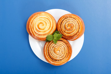 Three cinnamon rolls on white plate
