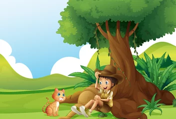 Foto op Plexiglas Een jongen en een kat onder de grote boom © GraphicsRF
