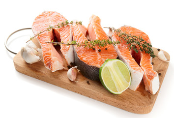 Raw trout steaks on cutting board isolated on white