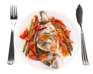 Roasted gilt-head bream with vegetables on plate, isolated on wh