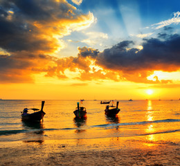 Traditional thai boats at sunset beach