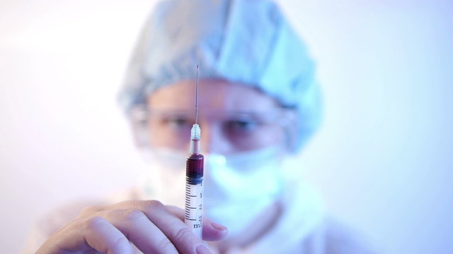 HD - Laboratory. Woman with syringe_front view